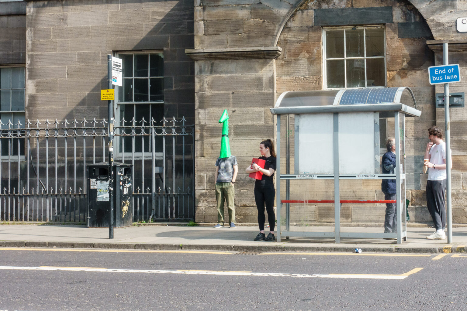 Wojtek, dressed as the Nessie monster, waits for the bus