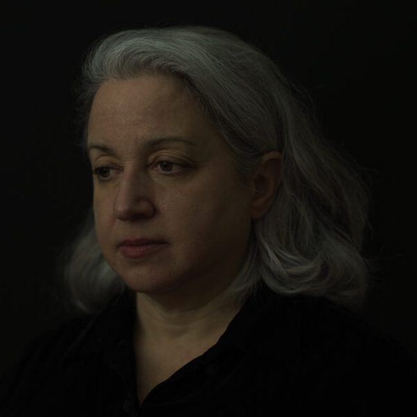A painterly photograph of Ruth, middle-aged woman, looking peacefully off-camera.